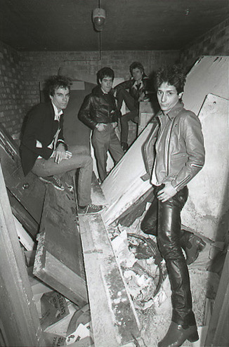 Band in a rubble-strewn basement, photographed by Leee Black Childers